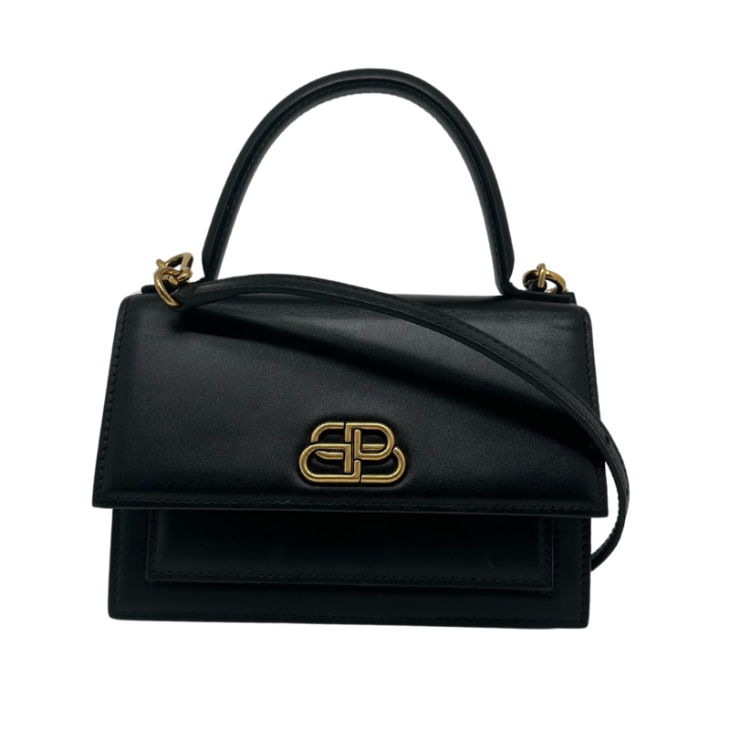 Black Leather Exterior and Interior Flap Top with Button Closure Gold-Toned Hardware Gold-Toned B Logo Structured Handle Detachable Strap Adjustable Strap One Main Compartment with Card Slot One Small Compartment Dust Bag Included