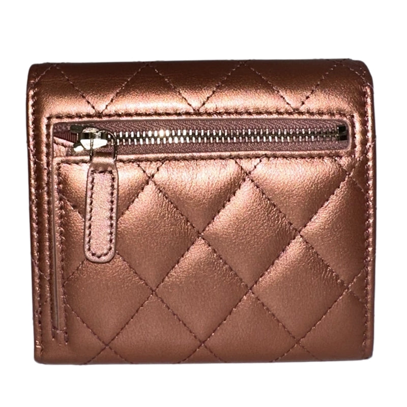 Chanel Compact Wallet&nbsp;  Rose Gold Quilt Exterior&nbsp;  Gold-Toned Hardware  Snap Closure  Zip Pocket on Exterior&nbsp;  Multiple Card Slots&nbsp;  Dust Bag Included&nbsp;