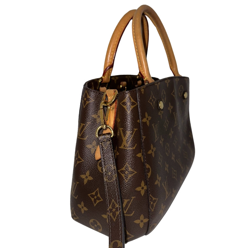 Louis Vuitton Montaigne BB&nbsp;  Brown Coated Canvas  Gold-Hardware  Leather Trim Embellishment&nbsp;  Rolled Handles&nbsp;  Single Shoulder Strap  Suede Lining&nbsp;  Interior Pockets  One Center Zip Pocket&nbsp;