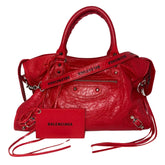 Balenciaga Motorcross City Bag&nbsp;

Red Exterior&nbsp;

Twiggy Model Bag

Zip Closure&nbsp;

Multiple Interior Pockets&nbsp;

Balenciaga Font Across Strap&nbsp;

Top Handles &amp; Adjustable Strap&nbsp;