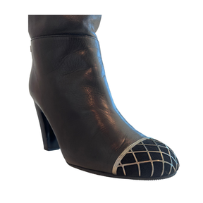 View of Toe on Chanel Interlocking CC Metal Cap Toe Knee-High Leather Boots on a White Bckground