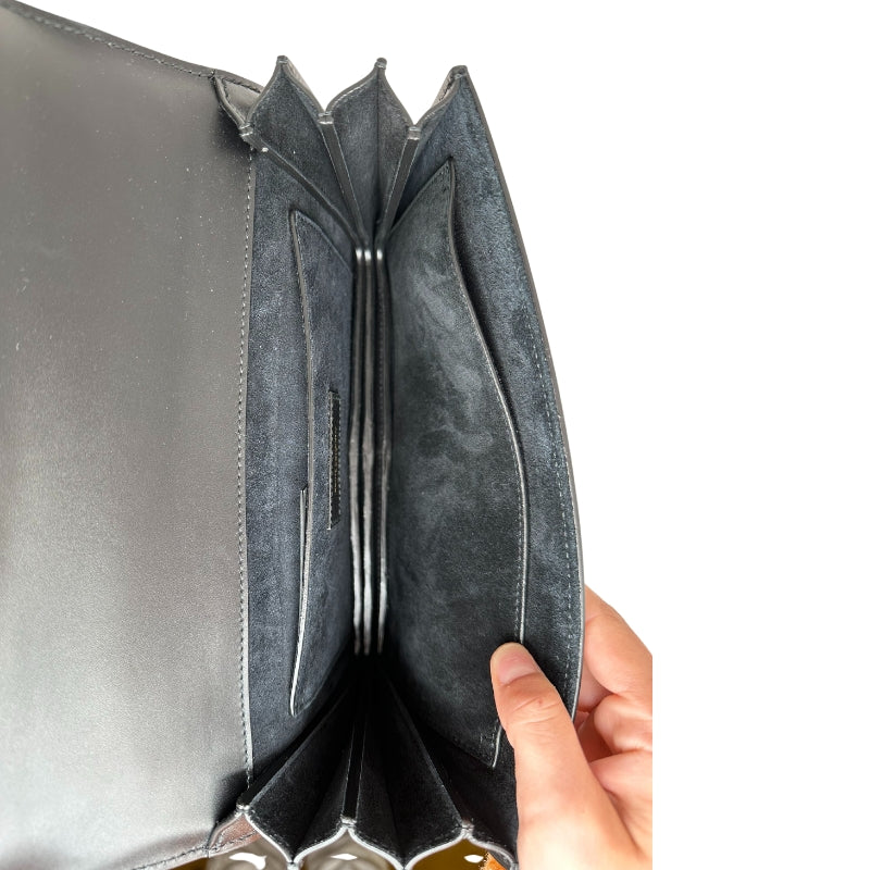 Saint Laurent Mono Dylan Bag Black Calfskin Exterior Monogram Gold-Toned Features Black Leather Shoulder Strap Front Flap with Magnetic Closure Black Suede Interior Single Pocket in Back Two Pockets in Interior 