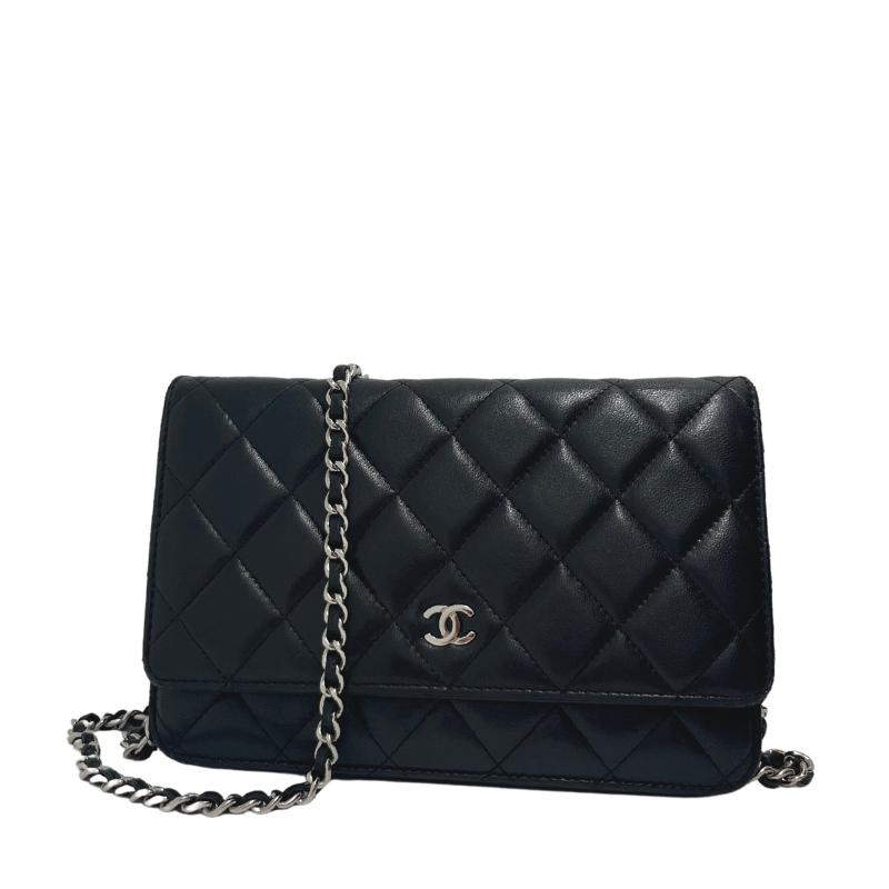 Chanel lambskin classic wallet on chain, black quilted lambskin leather exterior, silver hardware, single chain shoulder strap, silver cc logo at front snap closure, grosgrain lining, four interior pockets with card slots, condition excellent, front view