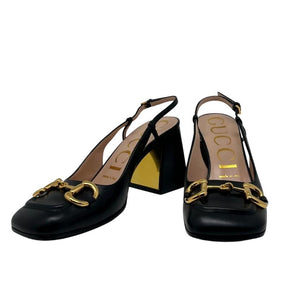 Gucci mid-heel slingback with horsebit, black leather exterior, gold horsebit hardware on front, gold on inside of heel, adjustable strap around ankle rounded toe, block heel, heel height 3", size 37, condition excellent