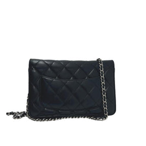 Chanel lambskin classic wallet on chain, black quilted lambskin leather exterior, silver hardware, single chain shoulder strap, silver cc logo at front snap closure, grosgrain lining, four interior pockets with card slots, condition excellent, exterior pocket, back view