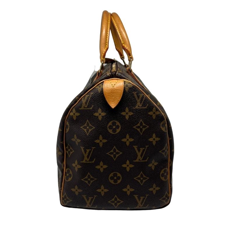 Louis Vuitton logo speedy 30, brown monogram coated canvas exterior, rolled handles, top zipper closure, canvas lining, single interior pocket, brass hardware, condition good, side view