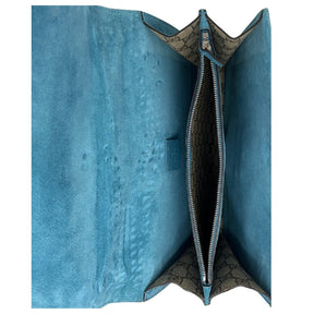 Interior View: Light Blue Suede, Leather Inner Flap, Partitioned Interior, Zipper Pocket.