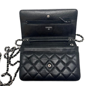 Chanel lambskin classic wallet on chain, black quilted lambskin leather exterior, silver hardware, single chain shoulder strap, silver cc logo at front snap closure, grosgrain lining, four interior pockets with card slots, condition excellent, top view