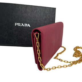 Prada Wallet on Chain with dark pink leather, gold tone hardware, chain link shoulder strap, interior pockets and card slots. Great condition