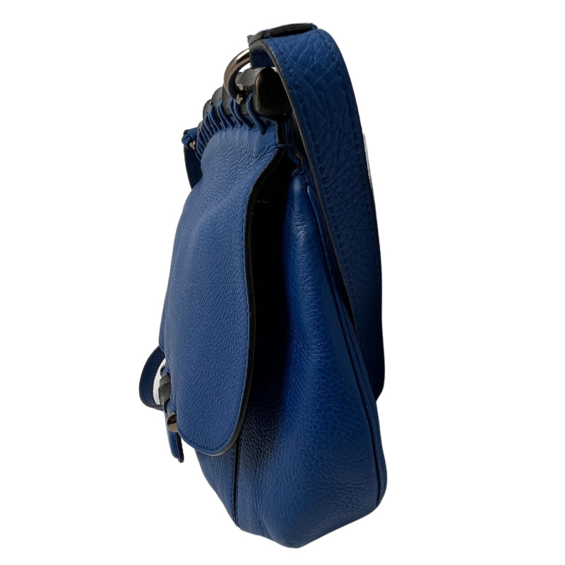 Side View: Blue Leather, Flap Bag, Two Tassels, Bamboo Top and Accents, Adjustable Leather Shoulder Strap.