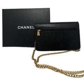 Chanel Caviar Timeless Wallet on Chain with black caviar leather, gold tone hardware, interlocking CC logo, chain link strap, card slots, exterior and interior pockets. Good condition with some scuffs on the interior