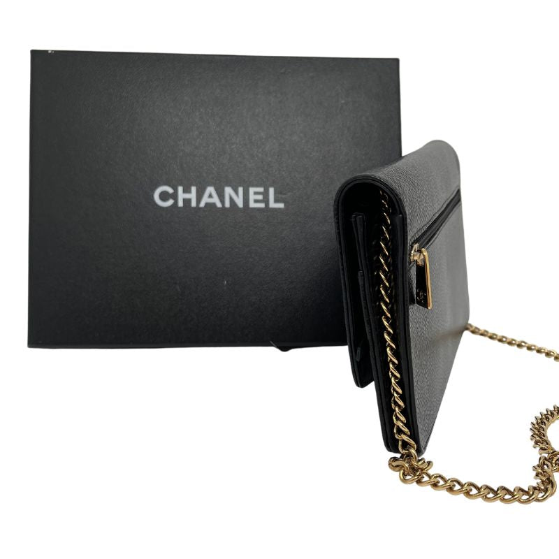Chanel Caviar Timeless Wallet on Chain with black caviar leather, gold tone hardware, interlocking CC logo, chain link strap, card slots, exterior and interior pockets. Good condition with some scuffs on the interior