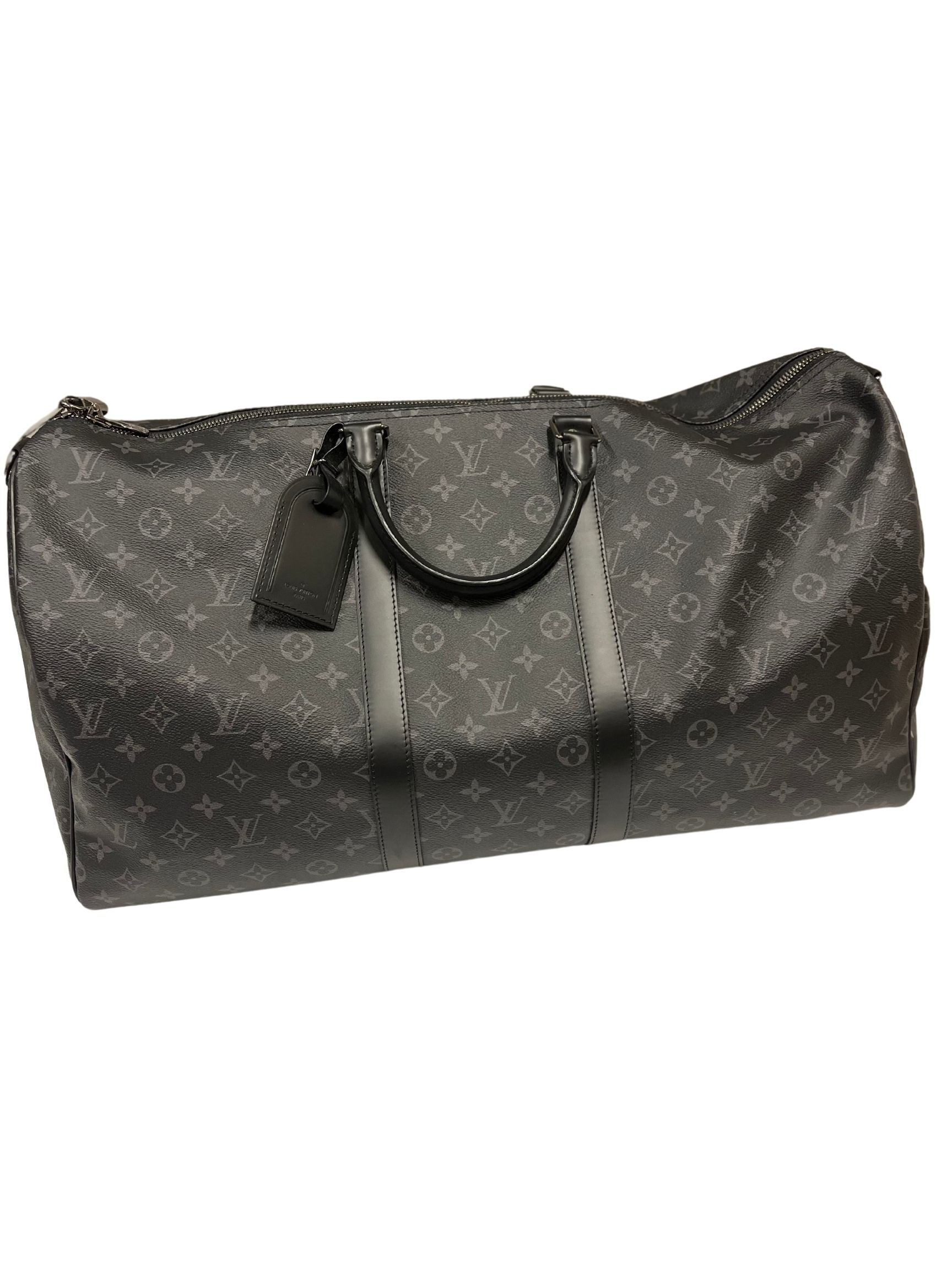 Louis Vuitton Monogram Eclipse Keepall | Coated Canvas | Cowhide Leather Trim | Double Zip Closure | Removable ID Holder | Adjustable, Removable Strap | Double Handles | Interior Zip Pocket | Padlock & Keys | Excellent Condition | Dust Bag Included