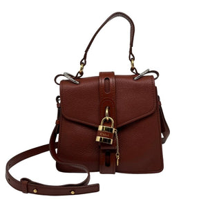 Chloe small aby day bag, brown leather exterior, gold hardware, chloe lock and key at front closure, adjustable shoulder strap, top handle, twill lining, dual interior pockets, condition excellent, front view