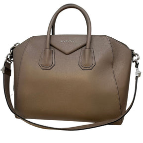 Givenchy Antigona Handle Bag in taupe leather with silver tone hardware, rolled handles and adjustable shoulder strap, zip closure at top, canvas lining, and three interior pockets. Excellent condition with dust bag