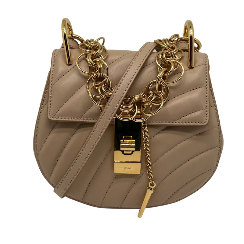 Front view: Tan quilted leather, Gold Hardware, attachable Crossbody Strap