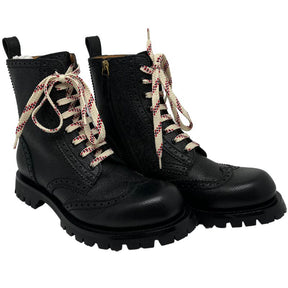 Gucci combat boots with black leather and rubber soles, laces and zippers on side. Excellent condition