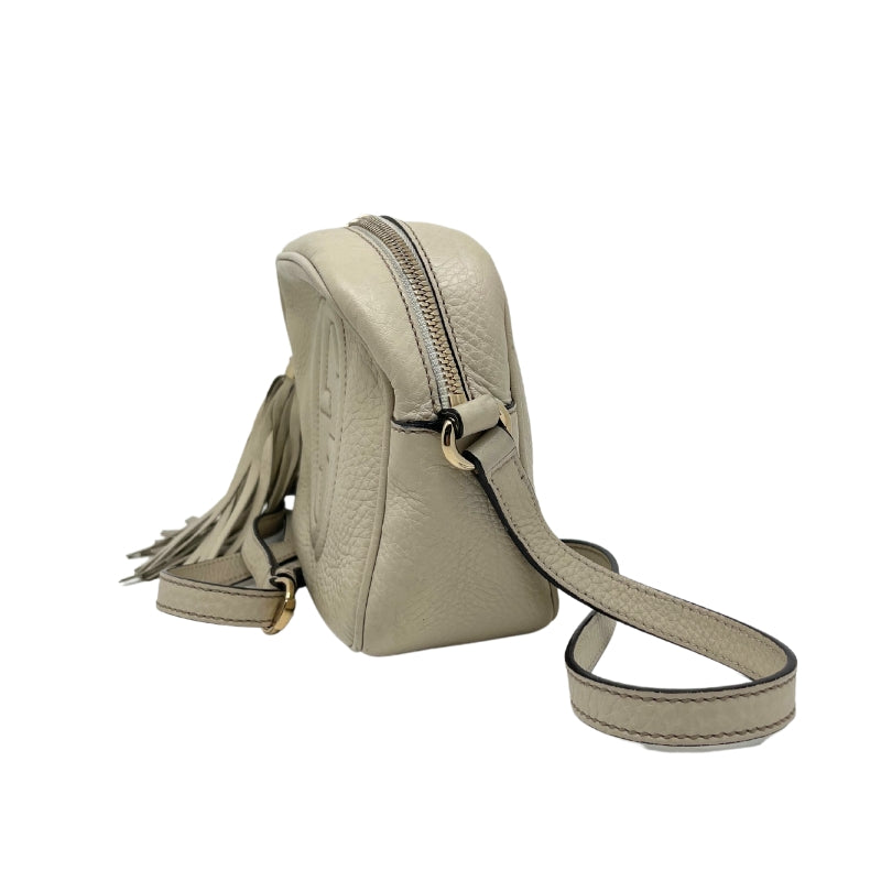 Gucci Soho Disco Crossbody Bag, Ivory Leather Exterior, GG Logo, Tassel Accent, Gold Tone Hardware, Single Adjustable Shoulder Strap, Canvas Lining, Dual Interior Pockets, Zip Closure at Top, Condition: Good