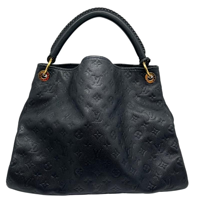 Louis Vuitton monogram empreinte artsy MM, black leather embossed lv logo exterior, single rolled handle, brass hardware, open top, braided accents, canvas interior, seven interior pockets, condition excellent, front view