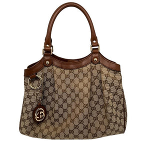 Gucci GG Canvas Sukey Tote, GG Canvas, Dark Brown Leather Trim, Gold-Tone Hardware, Two Leather Top Handles, Magnetic Snap Closure. Condition: Excellent.