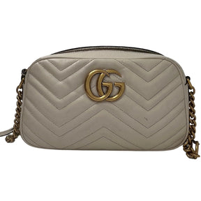 Front View: White Chevron Leather with GG on the Back, Gold-Tone Hardware, Double G, Adjustable Shoulder Strap, Zip Closure. 