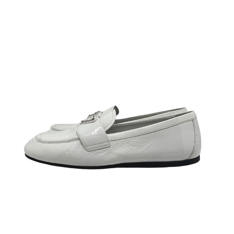 Prada white patent leather loafers, gold and white metal prada logo on front, white patent leather exterior, szie 38, rubber sole, penny loafer style, condition good with some exterior scuffs