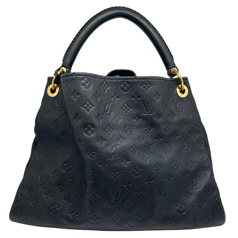 Louis Vuitton monogram empreinte artsy MM, black leather embossed lv logo exterior, single rolled handle, brass hardware, open top, braided accents, canvas interior, seven interior pockets, condition excellent, back view