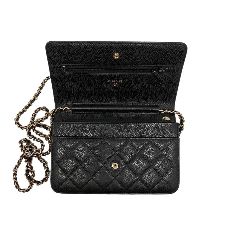 Chanel caviar wallet on chain, gold toned hardware, black quilted caviar leather, chain shoulder snap, single exterior pocket, dual interior pockets with card slots, flap closure at front, condition excellent, top view