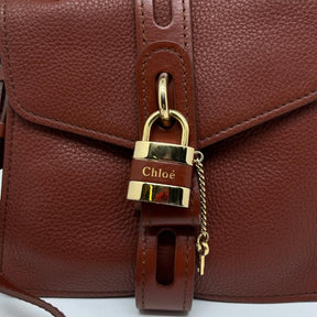 Chloe small aby day bag, brown leather exterior, gold hardware, chloe lock and key at front closure, adjustable shoulder strap, top handle, twill lining, dual interior pockets, condition excellent, front view