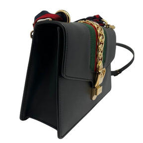 Gucci Sylvie Small Shoulder Bag, black leather with gold chain detail, red and green nylon web detail, black leather adjustable and removable shoulder strap, grosgrain ribbon shoulder strap. Excellent new condition