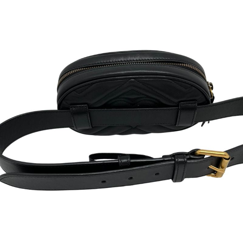 Gucci Mini Matelasse GG Marmont Belt Bag in black leather with gold tone hardware, adjustable waist strap, suede lining, and single interior pocket. Excellent condition