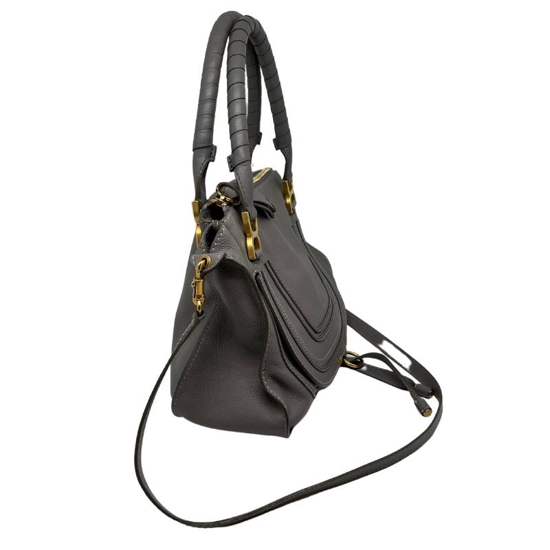 Chloe leather marcie bag, grey soft leather exterior, rolled dual handles, detachable shoulder strap, gold hardware, top zip closure, flap front closure with tassel, dual interior pockets, condition excellent, side view