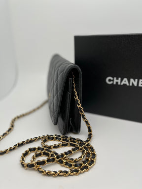 Classic Chanel Wallet on Chain | Black Quilted Leather | Gold Tone Hardware | Snap Front Closure | Chain Link Strap | Leather Lining | Burgundy Interior | Single Exterior Pocket | Interior Zippered Pocket & 6 Card Holders | Great Condition | Box Included