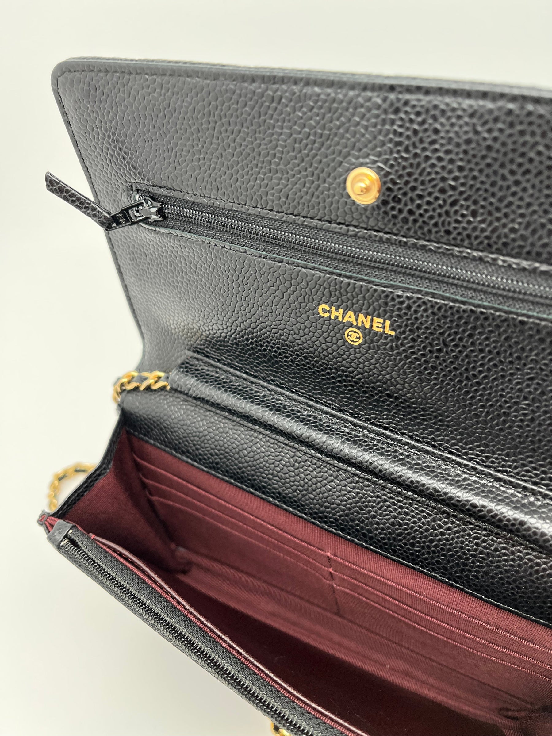 Classic Chanel Wallet on Chain | Black Quilted Leather | Gold Tone Hardware | Snap Front Closure | Chain Link Strap | Leather Lining | Burgundy Interior | Single Exterior Pocket | Interior Zippered Pocket & 6 Card Holders | Great Condition | Box Included