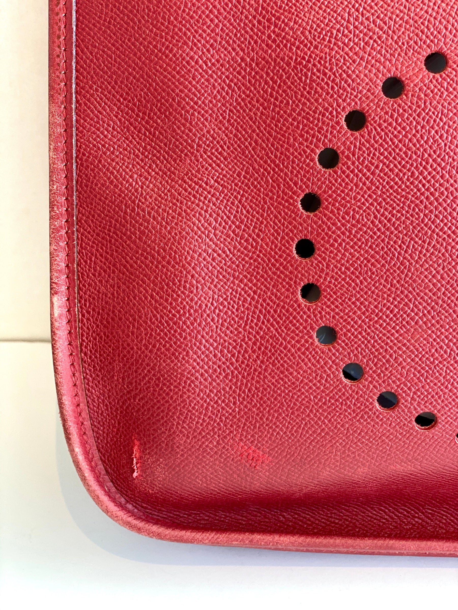 sign of wear on the red leather hermes bag
