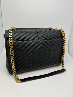 Saint Laurent Matelassè Collège Bag with black leather & gold tone hardware. Flat handle and chain link shoulder strap. One exterior pocket and divided interior with two interior pockets. Snap closure at front