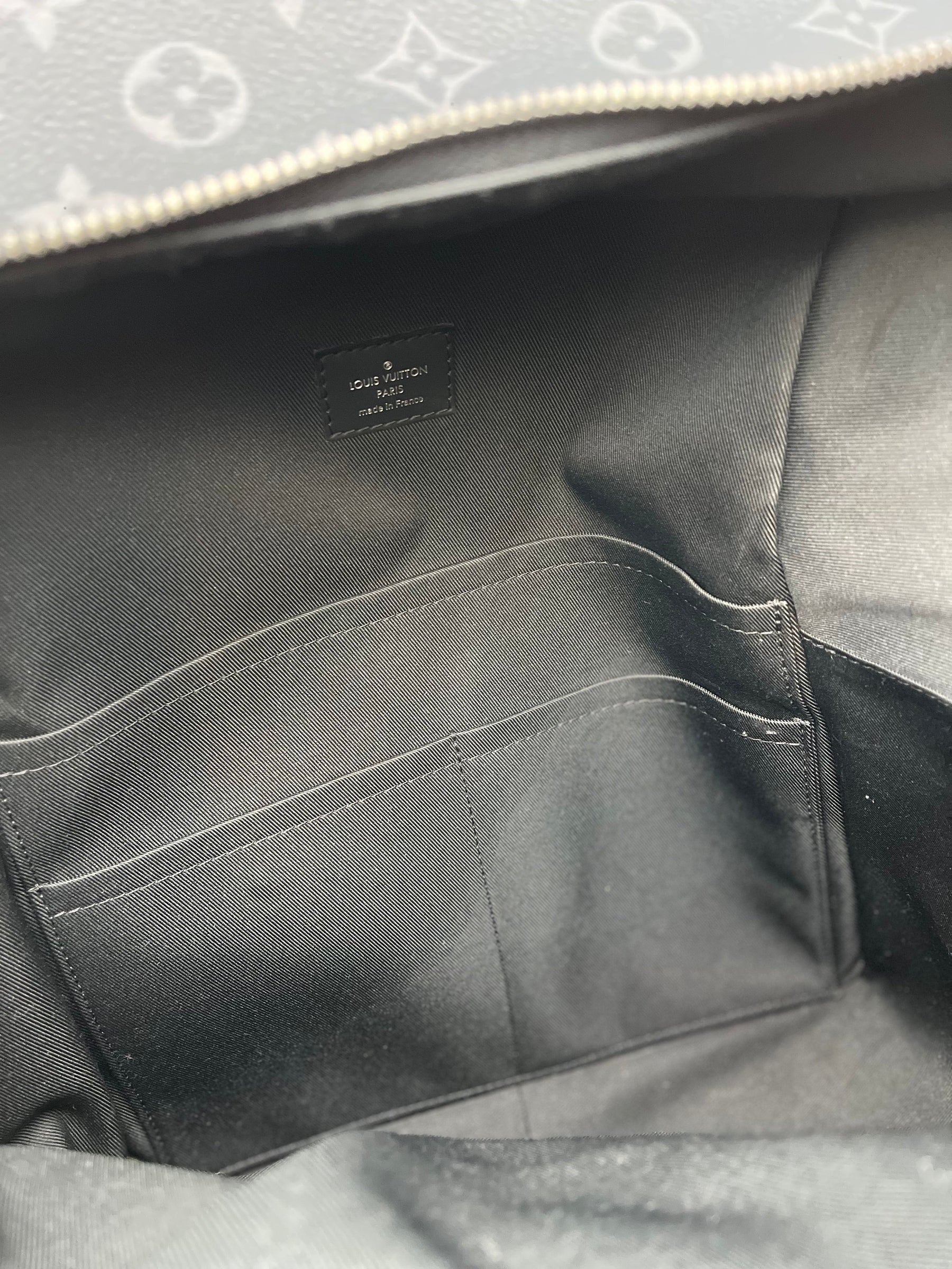 Cowhide Leather Trim | Ruthenium Metallic | Adjustable Black Leather Straps | 3 Internal Pockets | 2 Zippered Pockets | 1 Front Magnetic Closure Pocket | Top Handle | Excellent Condition