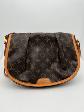 Louis Vuitton Menilmontant with Brown Monogram, brass hardware, and leather trim. Canvas interior with three interior pockets and magnetic closure. Great condition