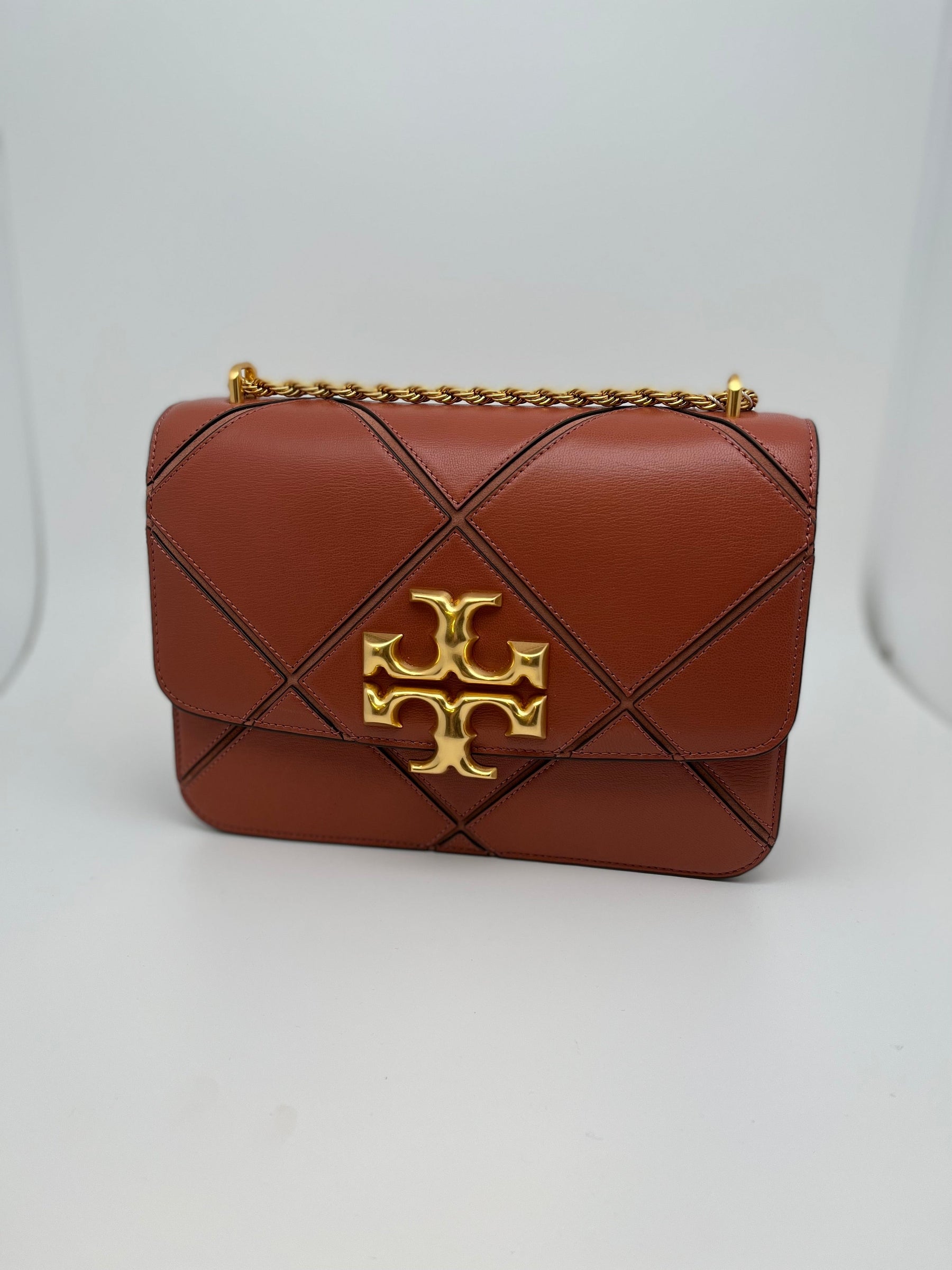 Tory Burch Eleanor Diamond Shoulder Bag with leather and gold toned hardware. Interior pockets and snap closure. New with tags