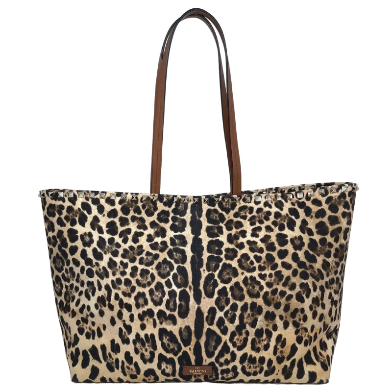 Valentino Rockstud Leopard-Print Canvas and Leather Tote  Studded Trim   Gold Tone Hardware  Leather Straps  Leopard-Print Canvas Exterior   Two Leather Valentino Logo Patch   Leather Lined Interior   Magnetic Top Closure   