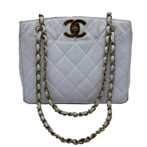 Chanel Vintage Caviar Quilted Turn Lock Open Top Tote  White Caviar Leather   Interlocking CC Turn Lock   Gold Tone Hardware  Chain Link Leather Straps   Two Exterior Flat Pockets   Open Top   Leather Interior   Two Interior Zipper Pockets 