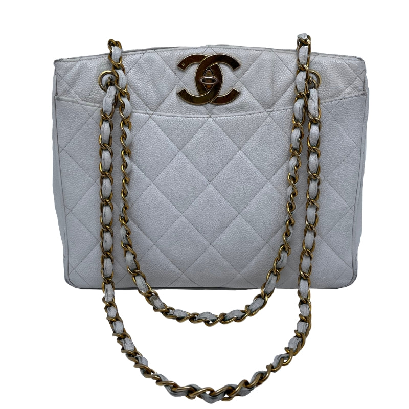 Chanel Vintage Caviar Quilted Turn Lock Open Top Tote  White Caviar Leather   Interlocking CC Turn Lock   Gold Tone Hardware  Chain Link Leather Straps   Two Exterior Flat Pockets   Open Top   Leather Interior   Two Interior Zipper Pockets 