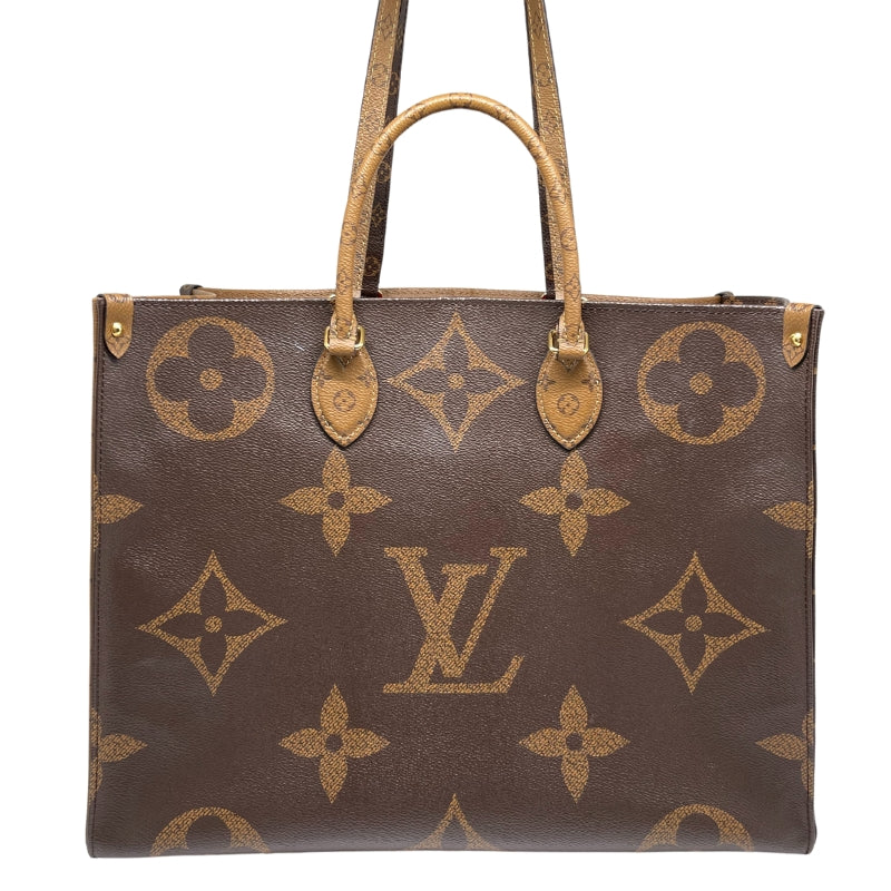 Louis Vuitton OnTheGo GM  Monogram and Monogram Reverse Coated Canvas Exterior   Gold Toned Hardware  Top Handles and Dual Shoulder Straps  Red Fabric Interior  Single Interior Zipper Pocket   Dual Interior Flat Pockets 