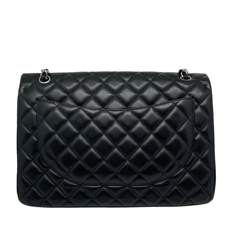 Chanel Maxi Single Flap Bag   Quilted Black Leather Exterior   Leather Threaded Chain-link Shoulder Straps  Silver Toned Hardware  Exterior Flat Pocket   CC Turn Lock Front Flap Closure  Maroon Leather Interior  Interior Flat Pocket   Interior Zipper Pocket 