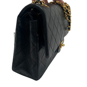 Chanel Double Flap Quilted Shoulder Bag  Black Leather Exterior  Gold Toned Hardware  Gold-Toned Chain-link Shoulder Strap  Single Exterior Back Pocket with Burgundy Leather Interior  Single Black Zipper Under First Flap  Burgundy Chanel Logo Under Second Flap  Three Interior Flat Pockets Under Second Flap