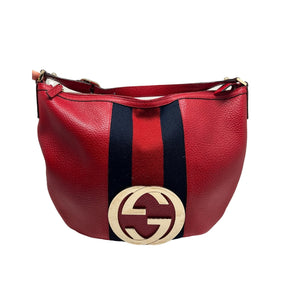 Gucci Large Blondie Bag  Red Leather Exterior   Red and Navy Large Fabric Stripe Down Center of Front Exterior  Gold Toned Hardware  Large GG Monogram Emblem   Single Zip Enclosure   Black Fabric Enclosure   Single Interior Flat Pocket with Zip Enclosure   Single Red Leather Shoulder Strap with Adjustable Buckle