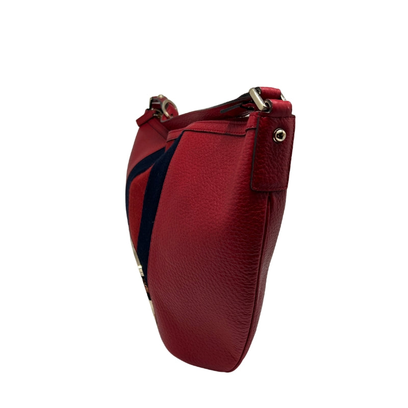 Gucci Large Blondie Bag  Red Leather Exterior   Red and Navy Large Fabric Stripe Down Center of Front Exterior  Gold Toned Hardware  Large GG Monogram Emblem   Single Zip Enclosure   Black Fabric Enclosure   Single Interior Flat Pocket with Zip Enclosure   Single Red Leather Shoulder Strap with Adjustable Buckle