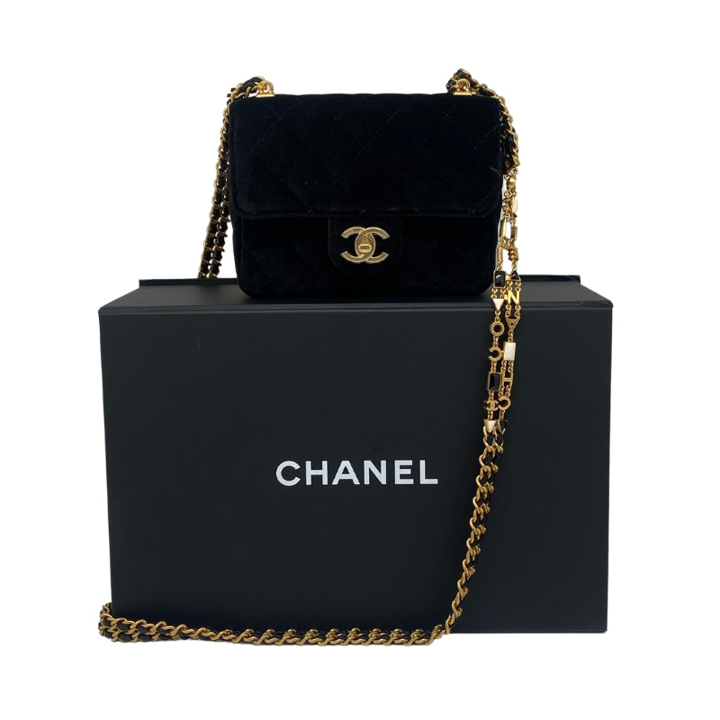 Chanel Mini Flap Velvet Bag Black Velvet Exterior   Gold Toned Hardware  Exterior Front Flap Enclosure  Chanel Monogram Clasp  Gold Toned Strap with Chanel Accent  Black Leather Interior   Single Interior Flat Side Pocket with Zip Closure