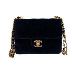 Chanel Mini Flap Velvet Bag Black Velvet Exterior   Gold Toned Hardware  Exterior Front Flap Enclosure  Chanel Monogram Clasp  Gold Toned Strap with Chanel Accent  Black Leather Interior   Single Interior Flat Side Pocket with Zip Closure