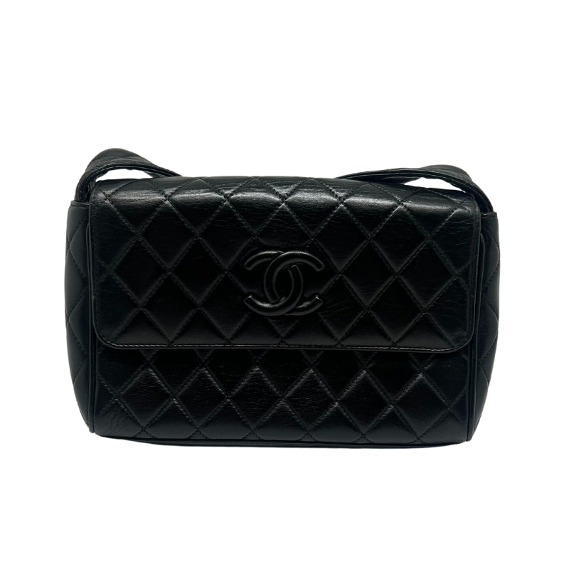 Chanel Quilted Leather Shoulder Bag  Black Leather Exterior   Gold Toned Hardware   Single Exterior Back Pocket with Burgundy Exterior   Single Quilted Leather Shoulder Strap  Front Flap Enclosure with Button Clasp  Chanel Monogram Emblem  Black and Burgundy Leather Interior   Double Interior Pockets on one Side 